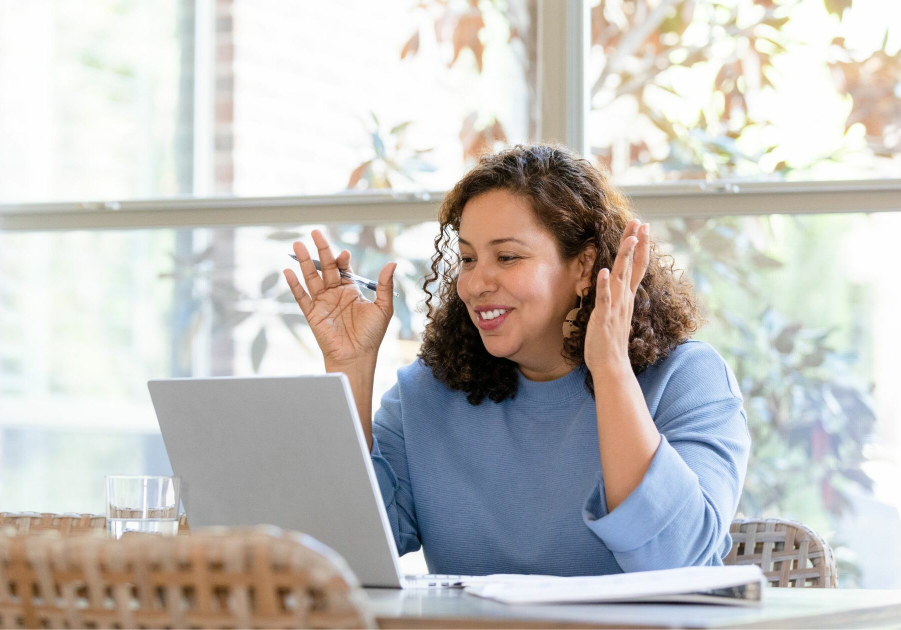 Woman with open computer video conferencing with her ADHD coach.